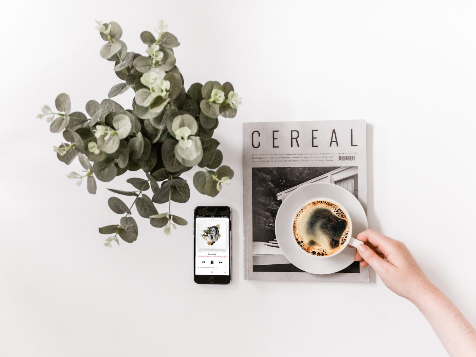 flat lay photography of smartphone, newspaper, and teacup