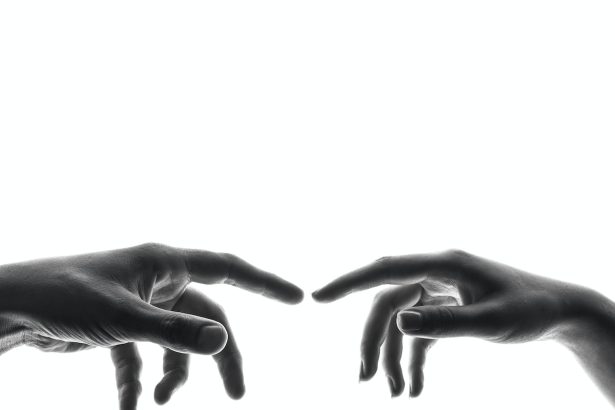 two person's connecting fingers